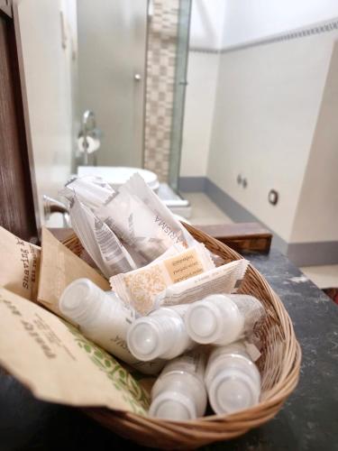 a basket of medicines on a counter in a bathroom at Ampio Appartamento Storico vicino alla Costa in Morciano di Romagna