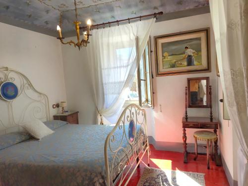 a bedroom with a bed and a window at Ampio Appartamento Storico vicino alla Costa in Morciano di Romagna