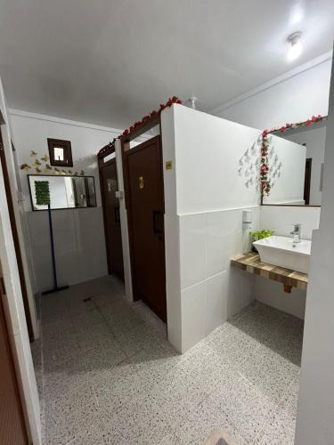 a bathroom with a sink and a toilet and a mirror at Ann's Place in Cabangan