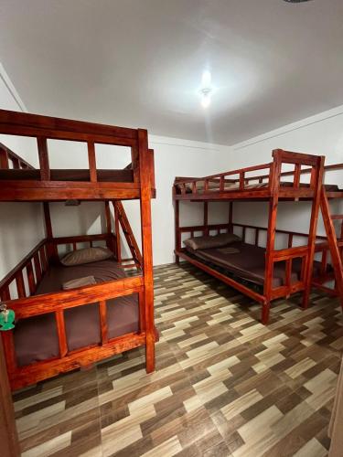 two bunk beds in a room with a wooden floor at Ann's Place in Cabangan
