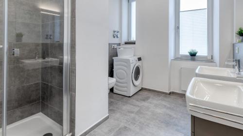 a bathroom with a shower sink and a toilet at Sali Homes - Opera Loge 2BR Balcony in Bayreuth