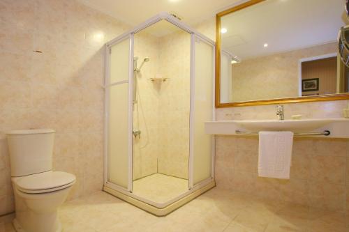 a bathroom with a shower and a toilet and a sink at Life Leisure Resort in Guanxi