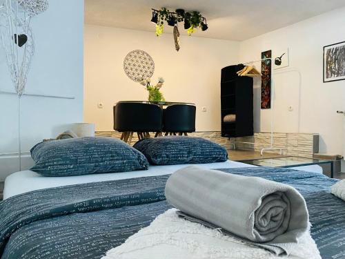 two beds with blue pillows in a room at Hot Jacuzzi & Ice Bath Apartment in Ika