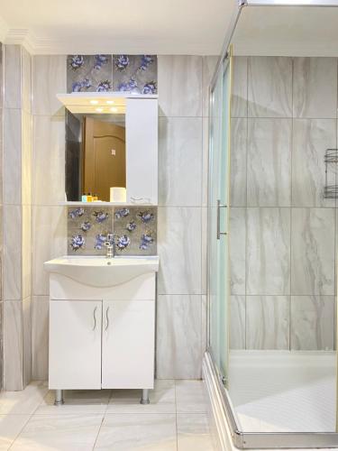 a bathroom with a sink and a shower at Emir Palas Hotel in Ekincik