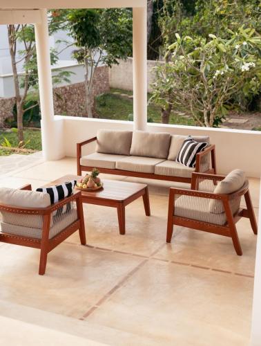 a living room with a couch and two chairs and a table at Little Maua - Stylish Private Hideaway on Galu Beach in Galu