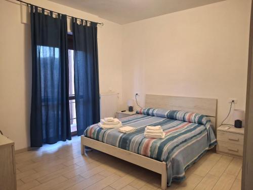 a bedroom with a bed with blue curtains at Al' Rrigo in Bolsena