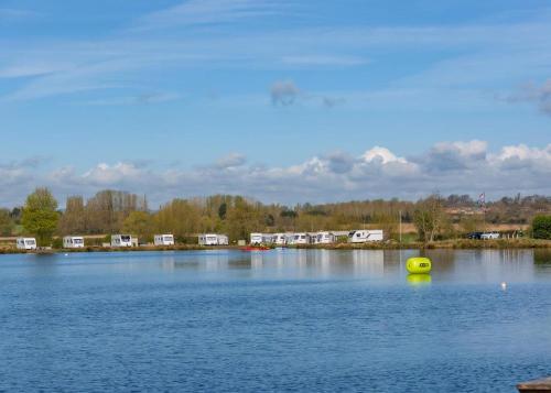 a yellow ball in the middle of a large lake at Croft Farm Water Park in Tewkesbury