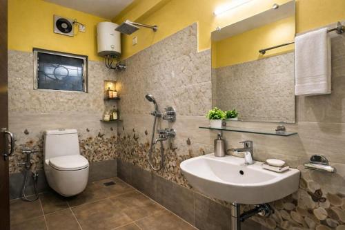 a bathroom with a sink and a toilet at Collection O Yellow Rose in kolkata