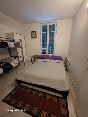 a small bedroom with a bed and a window at PR2 - 2 Bedrooms and a Fully Equipped Kitchen in Le Blanc-Mesnil