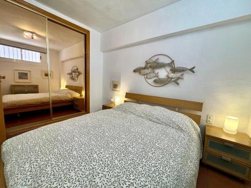 a bedroom with a bed and a large mirror at Marenostrum view in Playa Pobla de Farnals