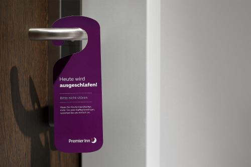 a purple door tag is attached to a door at Premier Inn München City Zentrum in Munich