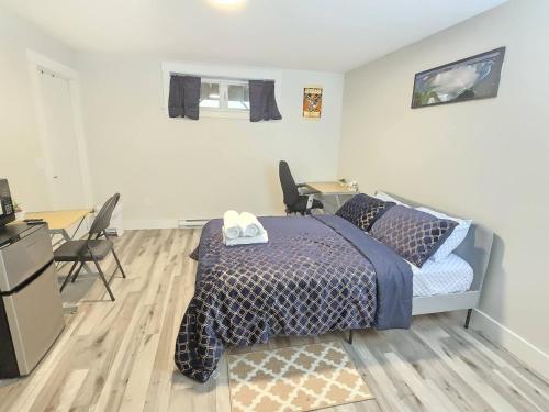 a bedroom with a bed and a desk with chairs at Cozy Newly Built Room in Halifax