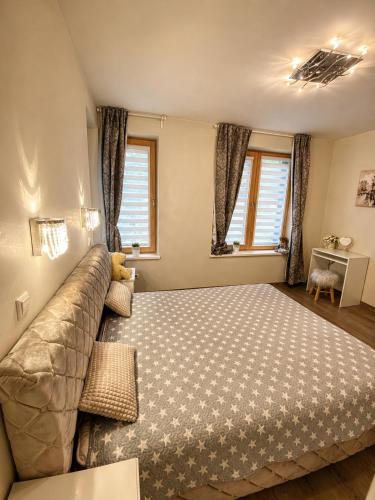 a bedroom with a bed and a couch at Klaipeda Seaside Apartments with self check-in in Klaipėda