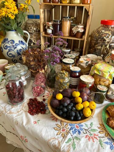 a table with a bunch of fruits and vegetables on it at Zameczek in Mikołajki