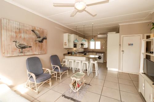 a kitchen and living room with chairs and a table at Sue Casa 3 in Margate