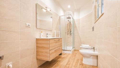 a bathroom with a toilet and a sink and a mirror at casa del sole in Taormina