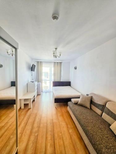 a living room with a couch and a bed at U Piotra in Sarbinowo