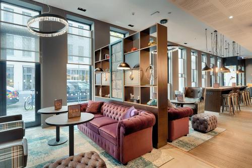 a living room with a couch and a table at Premier Inn Berlin Alexanderplatz in Berlin