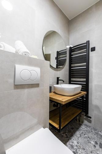 a bathroom with a sink and a mirror at Hotel Klek in Ogulin