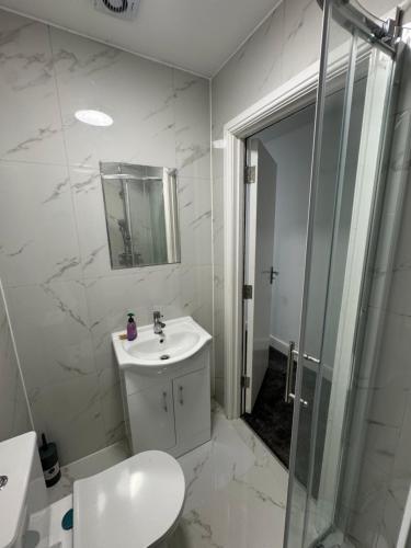 a bathroom with a toilet and a sink and a shower at London Heathrow Uxbridge Escape in Uxbridge