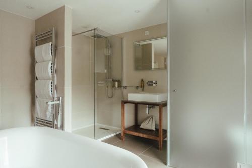 a bathroom with a glass shower and a sink at Winemaker's Pub in Goudhurst