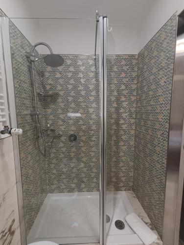 a shower with a glass door in a bathroom at Rolando 20B in Genoa
