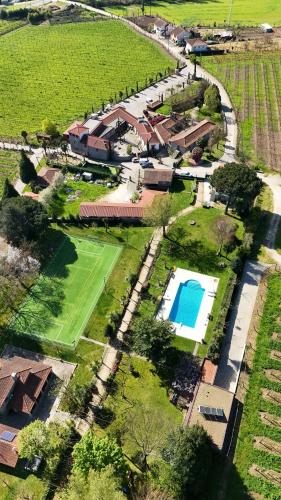 an aerial view of a house with a tennis court and a yard at Quinta de Maderne in Felgueiras