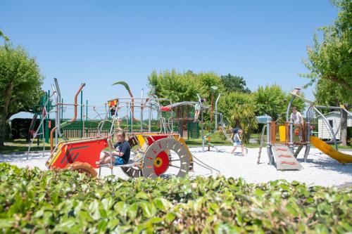 a group of children playing on a playground at la ferme des 4 chenes in Urt