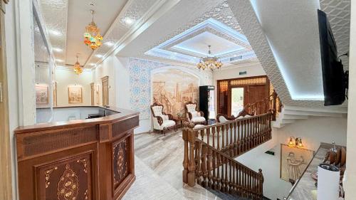 a home with a staircase and a living room at Saroy Khiva in Khiva