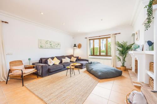a living room with a couch and a table at Villa Cal Peso in Port de Pollensa