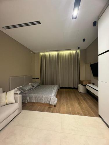 a bedroom with a bed and a couch in it at Sea Breeze Lighthouse 3 Studio ML in Nardaran