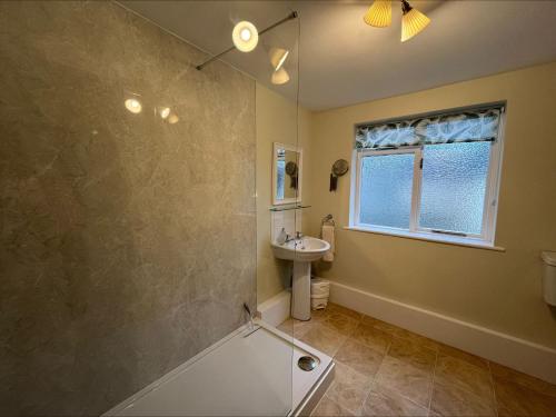 a bathroom with a shower and a sink at Castle Lodge Haughton Castle in Hexham