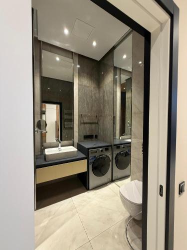 a bathroom with two washing machines and a sink at Sea Breeze Lighthouse 3 Studio ML in Nardaran