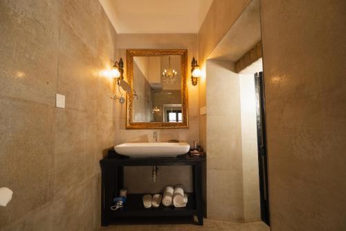 a bathroom with a sink and a mirror at Fort Tiracol Goa in Arambol