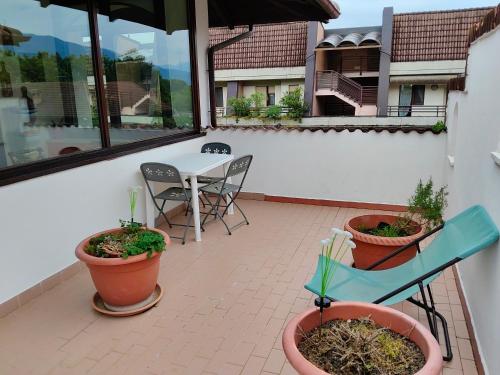 a patio with a table and chairs and plants at Casa Jesus - suite home in Almese