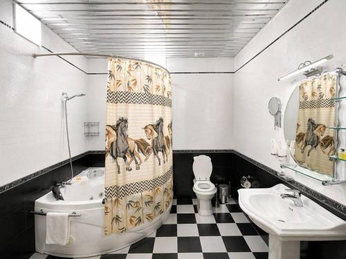 a bathroom with a horse shower curtain and a sink at Hayot Hotel Skazka in Qarshi