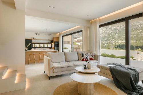 a living room with a couch and a table at Kisterna Luxury Living in Makriótika