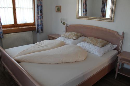 a bed with two pillows on it in a bedroom at Ferienwohnung Weingärtner in Oberstdorf