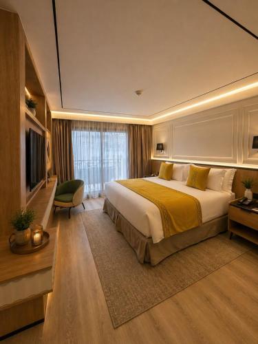 a hotel room with a large bed and a television at L'ADRESSE Boutique Hôtel & SPA Tanger in Tangier