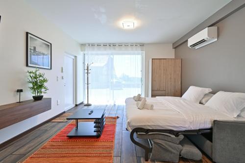 a bedroom with a large bed and a table at Studio 42m² Design in Annecy
