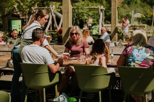a group of people sitting at a table at Vakantiehoeve Si-Es-An in Balkbrug
