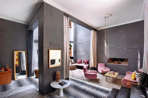 a living room with pink chairs and a couch at El Fenn in Marrakesh