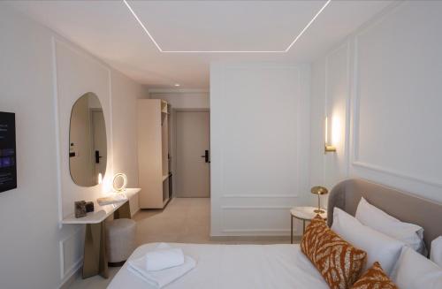 a hotel room with a bed and a mirror at The Grand Blue Boutique Hotel in Missolonghi