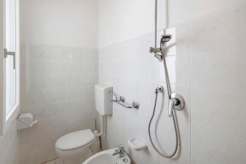 a bathroom with a shower and a toilet at Residenza Stella X in Bibione