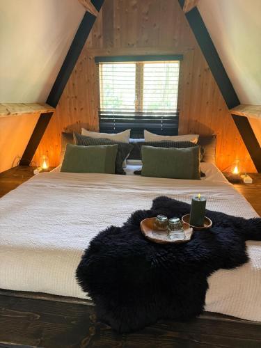 a bedroom with a large bed with a tray on it at Het Dubbele Punthuisje in Lanaken