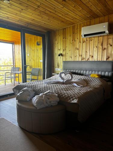 a bedroom with a bed with towels on it at Makárlux Vendégház in Pécs