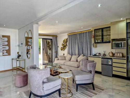 a living room with a couch and chairs and a table at Nandoni Waterfront Resort in Thohoyandou