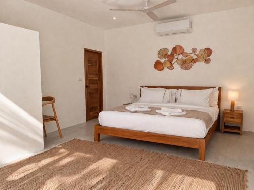 a bedroom with a bed and a table and a chair at Jungle Home in Koh Samui