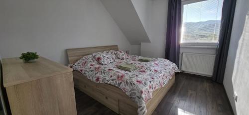 a small bedroom with a bed and a window at Apartmán STATION Vrútky centrum in Vrútky