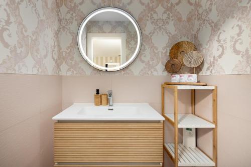 a bathroom with a sink and a mirror at WonderStays Villa Lucía in Málaga